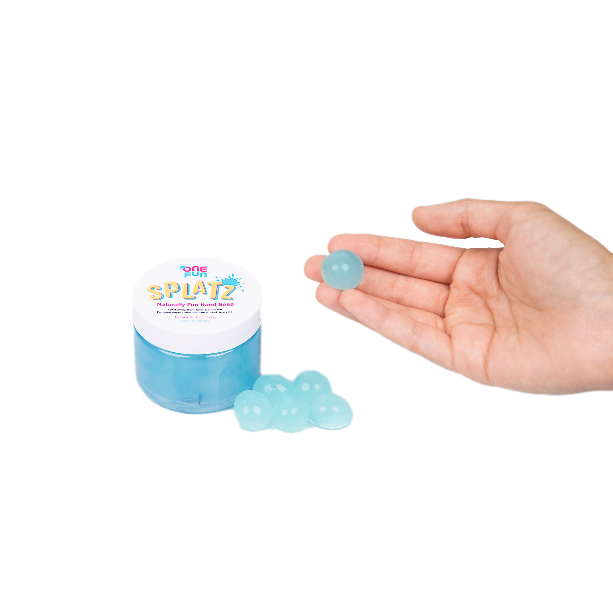 A 3oz jar of turquoise bursting soap bubbles and a hand holding out one turquoise bursting soap bubble.