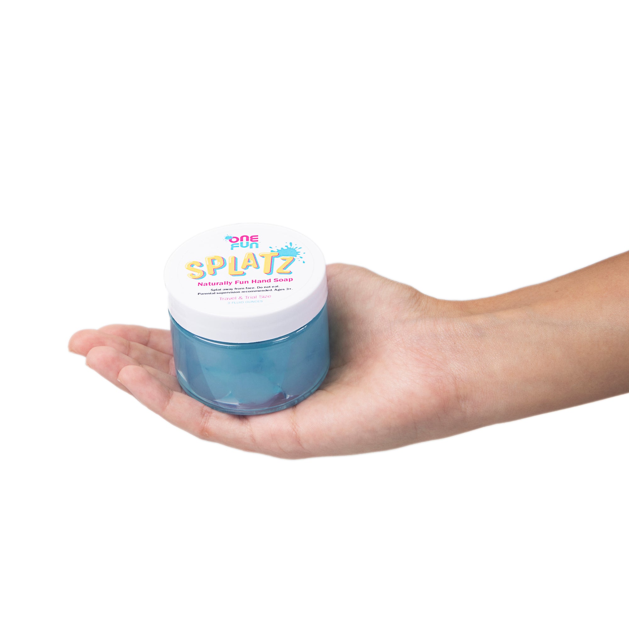 A 3oz jar of turquoise bursting soap bubbles held out in the palm of a hand