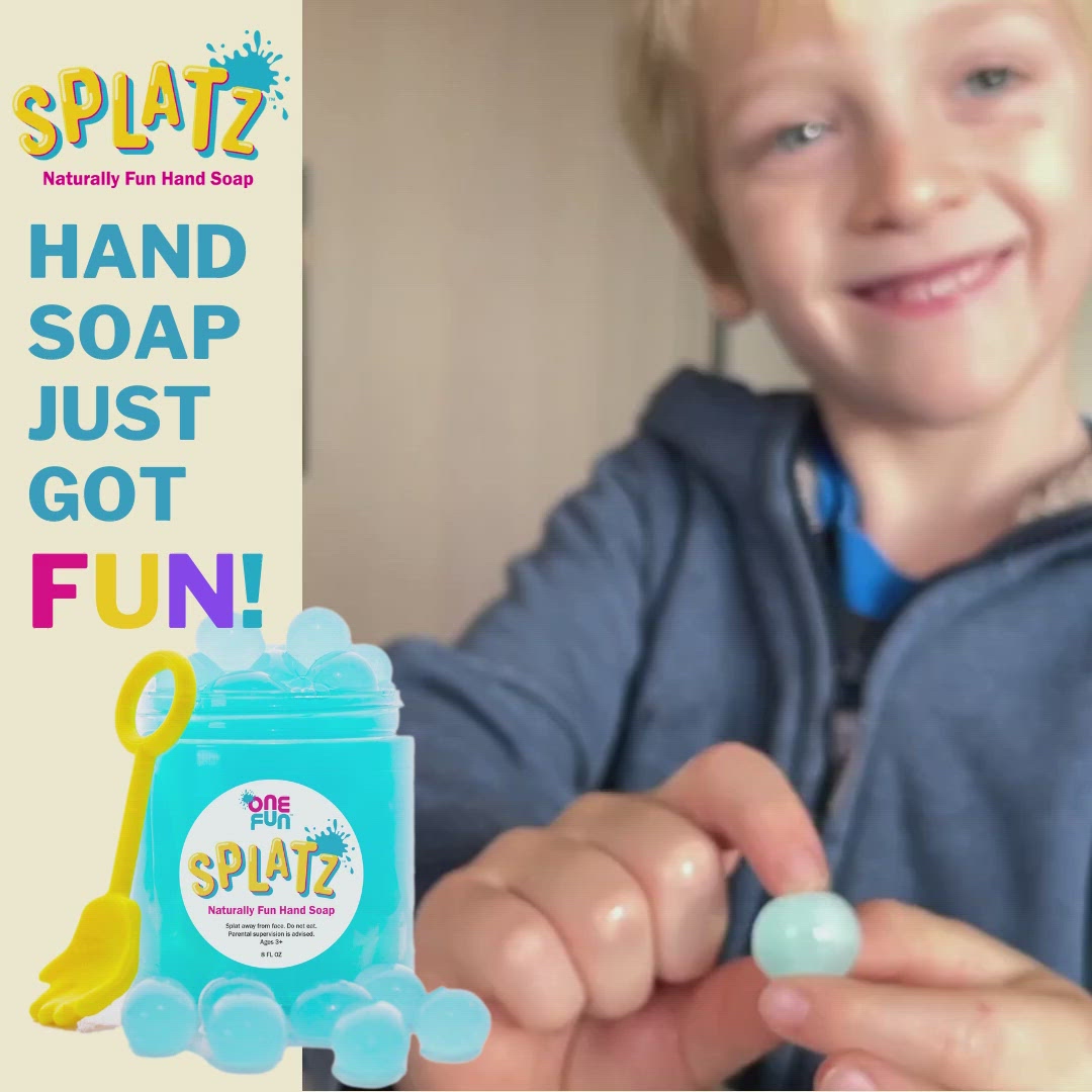 A video demonstrating small children popping turquoise bursting soap bubbles. With a picture of two small children holding up a Splatz hand towel with the phrase "wash your hands!" printed on it